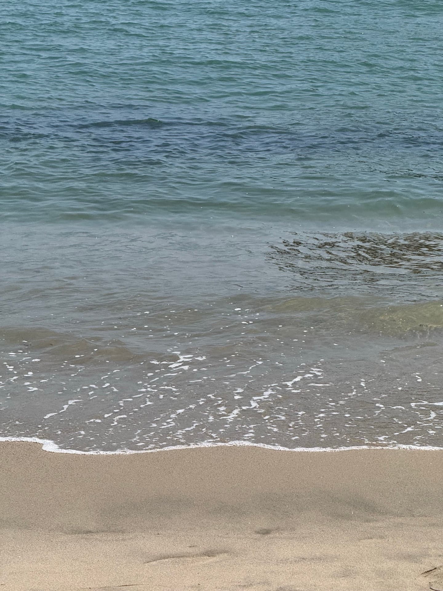 Small waves rolling up onto the sand